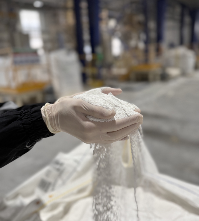 Soda ash running through hands with gloves