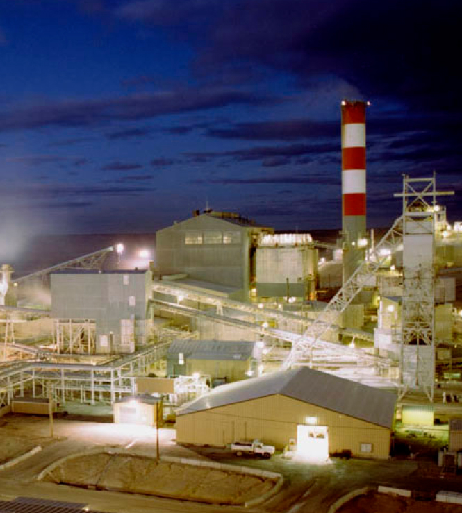 Soda ash processing plant lit up against night sky