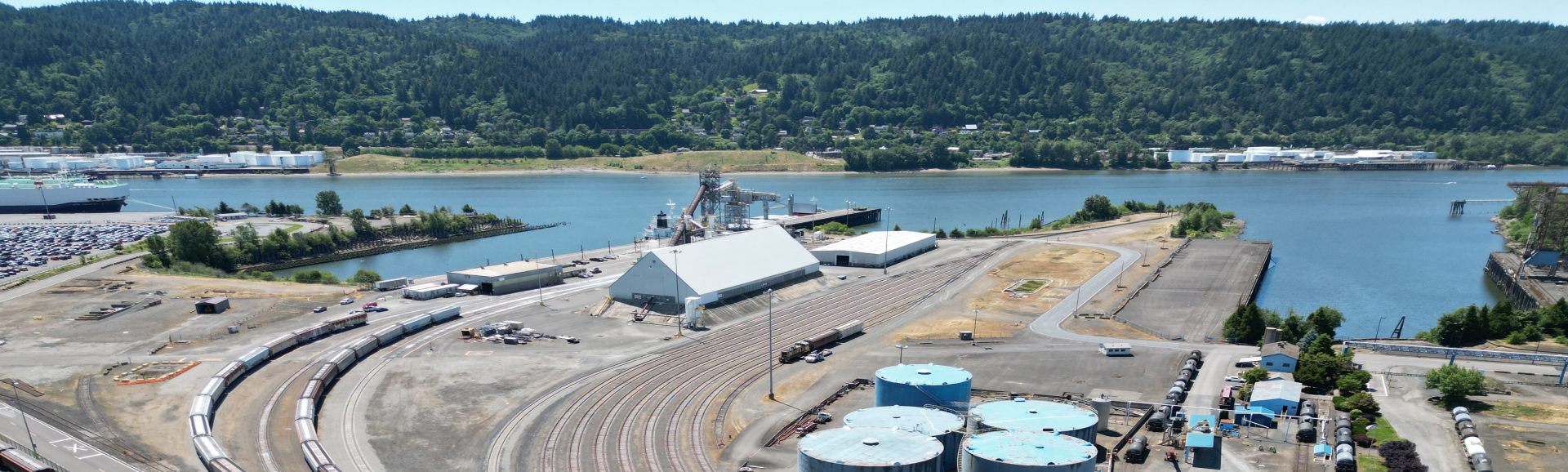 Soda ash processing plant landscape with sea and hills in background