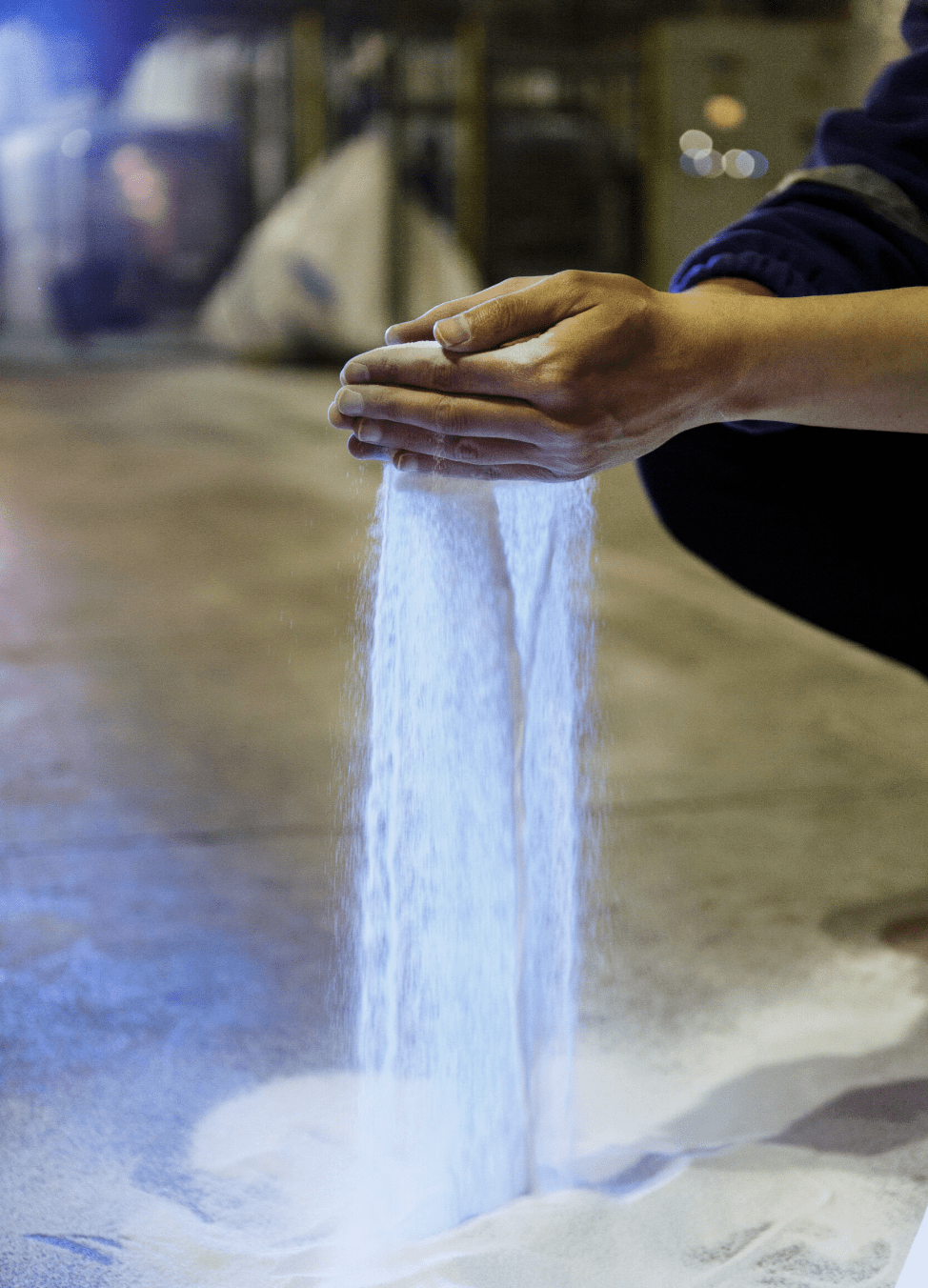 Soda ash running through person's hands